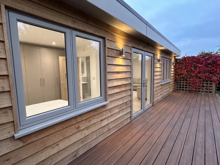 A close-up view of the windsor with green-oak cladding and composite decking area.